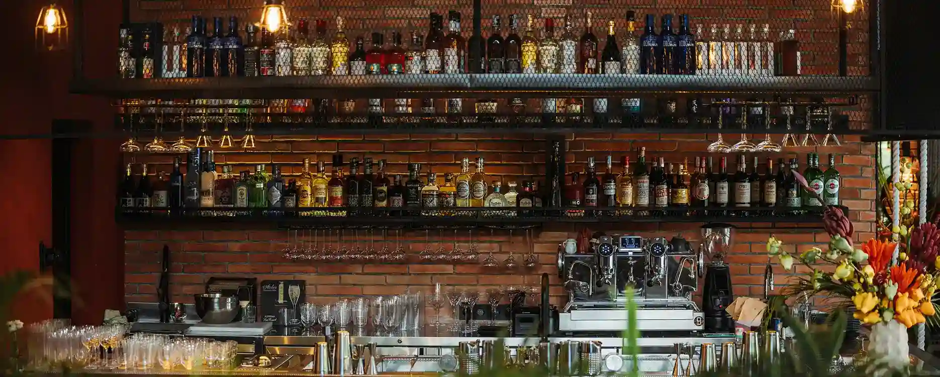 The bar with different alcohol drinks one the shelves